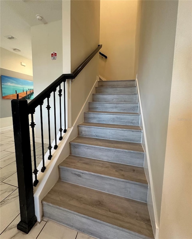 stairs featuring baseboards
