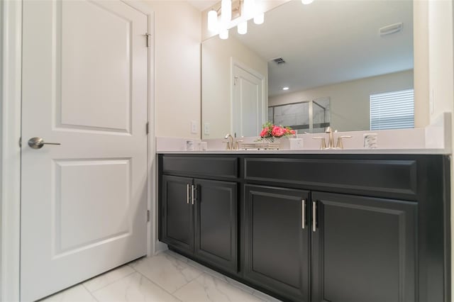 full bathroom featuring double vanity, a stall shower, visible vents, marble finish floor, and a sink
