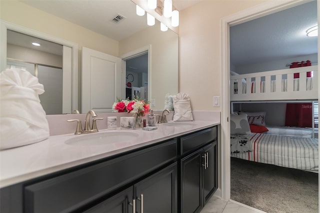 full bathroom featuring double vanity, visible vents, ensuite bath, and a sink