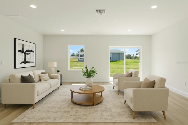 living area featuring wood finished floors, recessed lighting, and baseboards