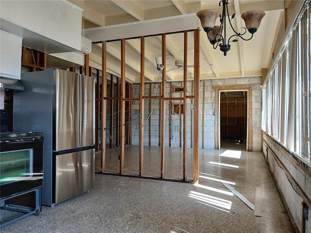 316 Country Club Dr, Oldsmar, FL 34677 - misc room featuring an inviting chandelier, concrete block wall, and speckled floor