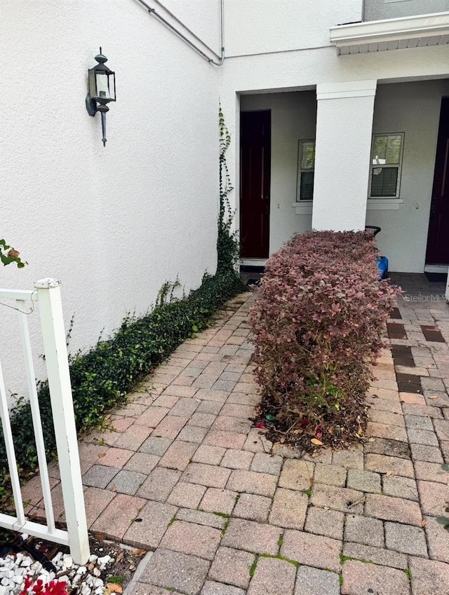 doorway to property with stucco siding