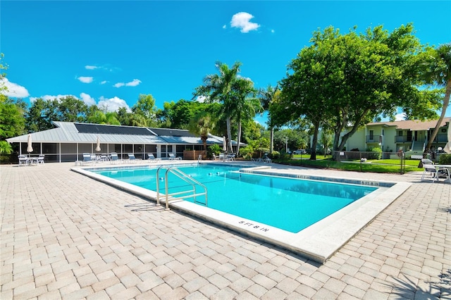 community pool featuring a patio area and fence