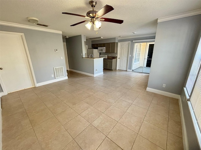 unfurnished living room with ornamental molding, light tile patterned floors, a textured ceiling, visible vents, and ceiling fan
