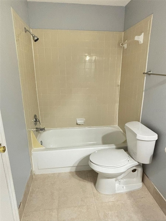 bathroom featuring toilet, tile patterned floors, baseboards, and shower / bath combination