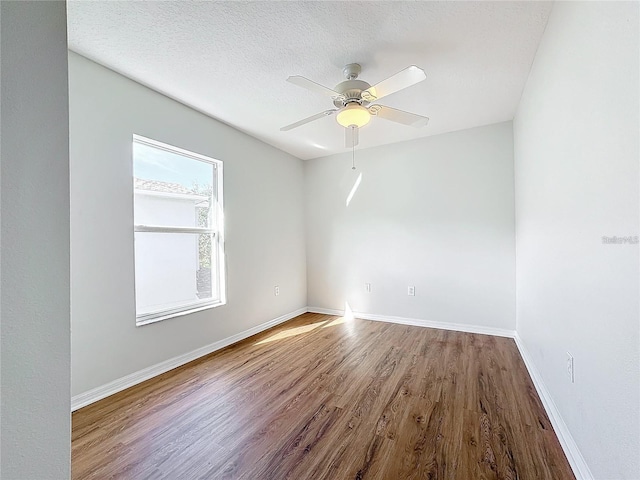 1176 Liberty Hall Dr, Kissimmee, FL 34746 - spare room featuring wood finished floors, a ceiling fan, and baseboards