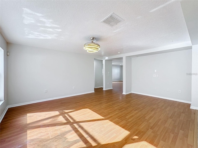 1176 Liberty Hall Dr, Kissimmee, FL 34746 - unfurnished room featuring wood finished floors, a textured ceiling, and baseboards