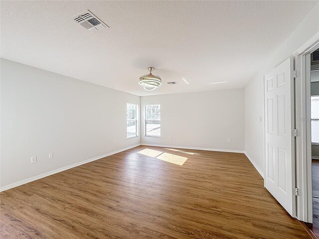 1176 Liberty Hall Dr, Kissimmee, FL 34746 - unfurnished room featuring dark wood finished floors, baseboards, and a textured ceiling