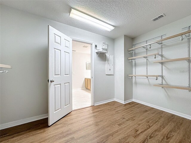 1176 Liberty Hall Dr, Kissimmee, FL 34746 - walk in closet featuring wood finished floors