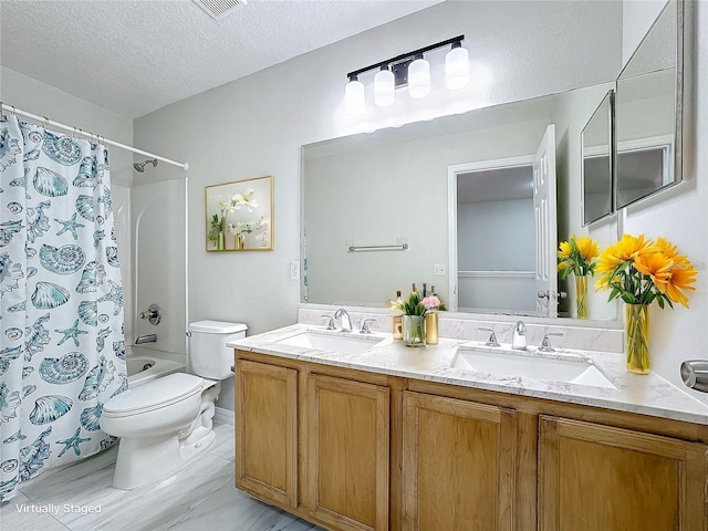 1176 Liberty Hall Dr, Kissimmee, FL 34746 - bathroom with toilet, double vanity, a textured ceiling, and shower / bath combo