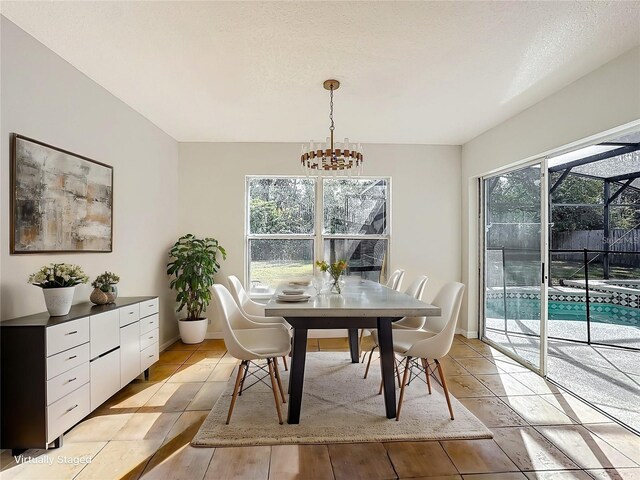 1176 Liberty Hall Dr, Kissimmee, FL 34746 - dining area with a chandelier and baseboards
