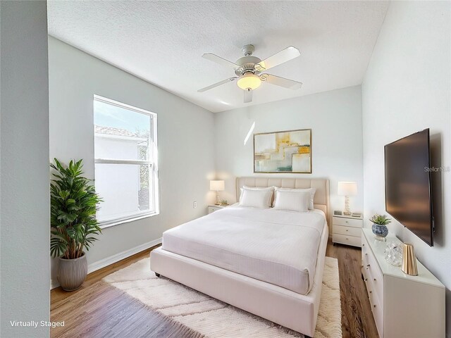 1176 Liberty Hall Dr, Kissimmee, FL 34746 - bedroom with wood finished floors, baseboards, and a ceiling fan