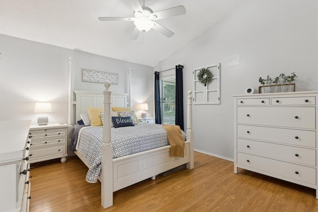 bedroom with ceiling fan, lofted ceiling, and light wood finished floors