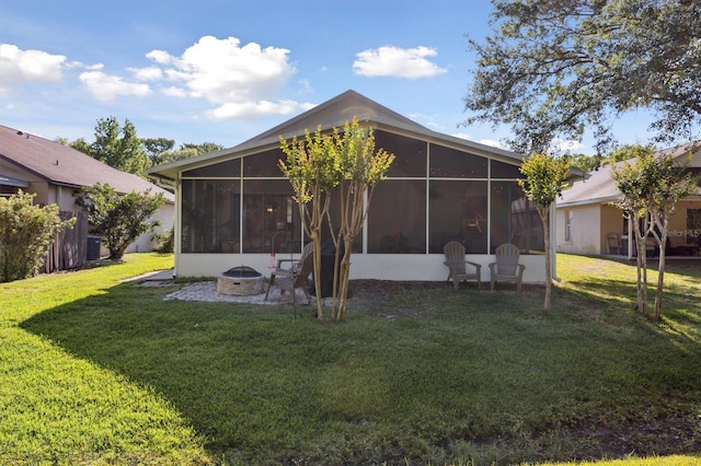 rear view of property with central AC unit, a sunroom, and a yard