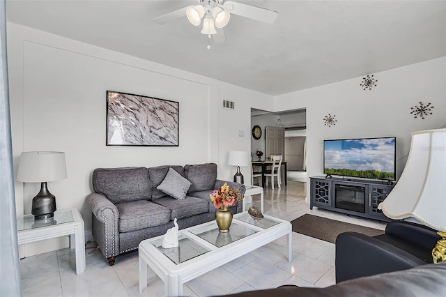 living area with visible vents and a ceiling fan