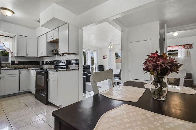 kitchen featuring visible vents, ceiling fan, dark countertops, and black / electric stove