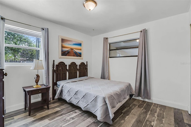 bedroom with wood finished floors and baseboards