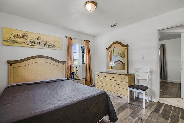 bedroom with visible vents and wood finished floors
