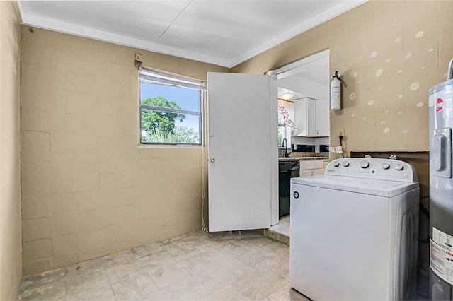 laundry area featuring washer / clothes dryer, water heater, crown molding, laundry area, and a sink