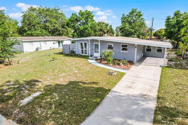 single story home featuring a front lawn, fence, an attached carport, and concrete driveway