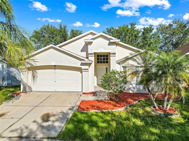 12511 Lake Vista Dr, Gibsonton, FL 33534 - view of front facade with driveway, stucco siding, and an attached garage