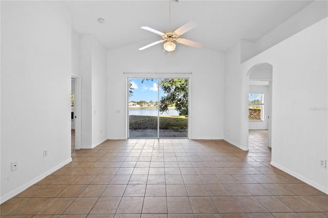 12511 Lake Vista Dr, Gibsonton, FL 33534 - unfurnished room featuring a water view, tile patterned floors, a ceiling fan, high vaulted ceiling, and arched walkways