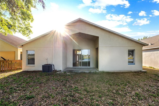 12511 Lake Vista Dr, Gibsonton, FL 33534 - back of property featuring stucco siding, cooling unit, and fence