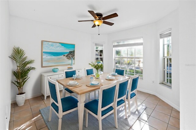 12511 Lake Vista Dr, Gibsonton, FL 33534 - dining room with baseboards, a ceiling fan, and light tile patterned flooring