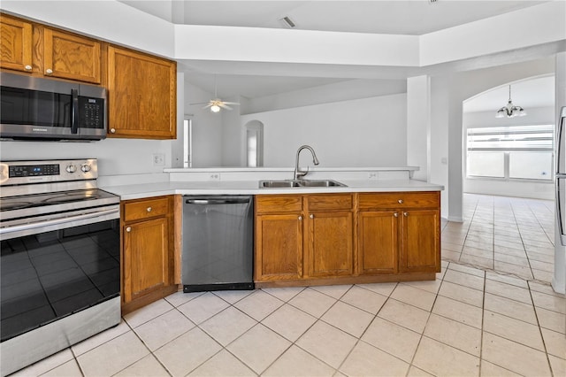 12511 Lake Vista Dr, Gibsonton, FL 33534 - kitchen featuring arched walkways, a sink, light countertops, appliances with stainless steel finishes, and ceiling fan with notable chandelier