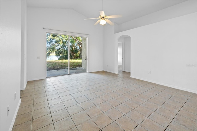 12511 Lake Vista Dr, Gibsonton, FL 33534 - spare room featuring arched walkways, light tile patterned floors, baseboards, and a ceiling fan