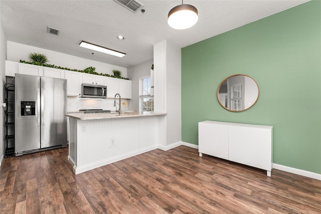 4897 Cypress Woods Dr Unit 6314, Orlando, FL 32811 - kitchen featuring white cabinets, appliances with stainless steel finishes, dark wood-style floors, and visible vents