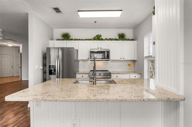 4897 Cypress Woods Dr Unit 6314, Orlando, FL 32811 - kitchen featuring visible vents, dark wood-style flooring, a sink, stainless steel appliances, and backsplash