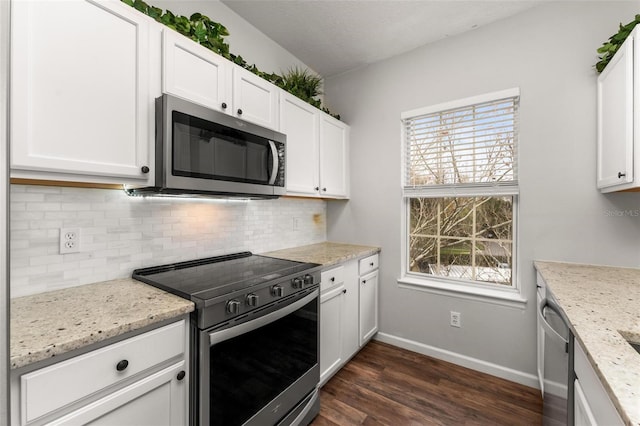 4897 Cypress Woods Dr Unit 6314, Orlando, FL 32811 - kitchen featuring dark wood finished floors, white cabinetry, appliances with stainless steel finishes, baseboards, and backsplash