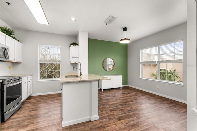 4897 Cypress Woods Dr Unit 6314, Orlando, FL 32811 - kitchen featuring dark wood-style flooring, baseboards, white cabinetry, light stone countertops, and stainless steel appliances