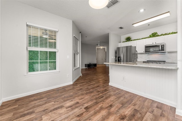 4897 Cypress Woods Dr Unit 6314, Orlando, FL 32811 - kitchen with dark wood-type flooring, visible vents, white cabinets, and stainless steel appliances