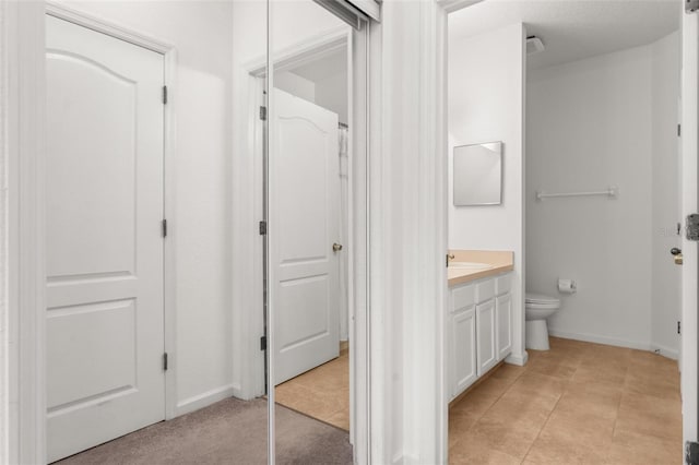 4897 Cypress Woods Dr Unit 6314, Orlando, FL 32811 - bathroom with toilet, vanity, baseboards, and tile patterned flooring