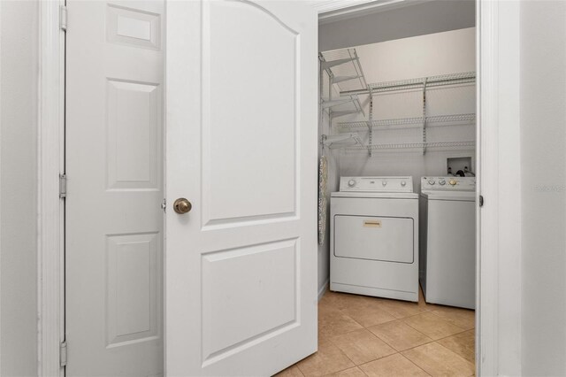 4897 Cypress Woods Dr Unit 6314, Orlando, FL 32811 - clothes washing area featuring washer and dryer, laundry area, and light tile patterned flooring