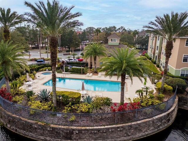 4897 Cypress Woods Dr Unit 6314, Orlando, FL 32811 - community pool featuring a patio area and fence
