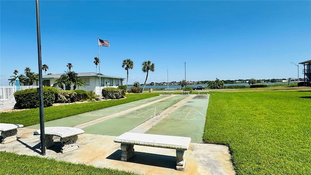 view of community featuring a lawn and shuffleboard