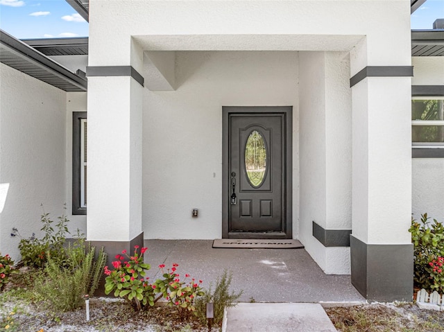 doorway to property with stucco siding