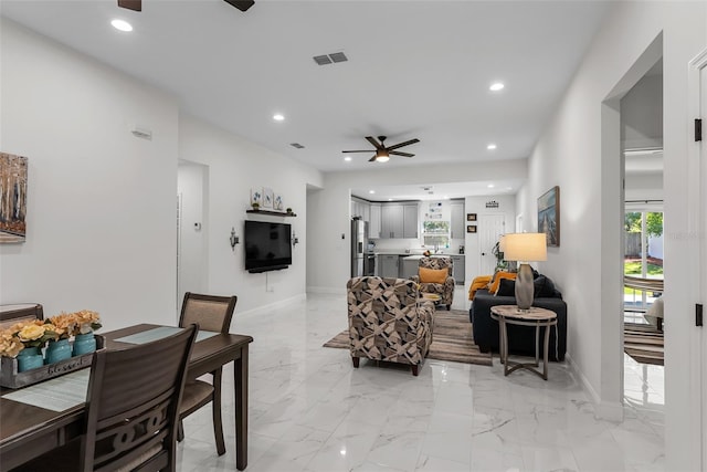 living room with recessed lighting, visible vents, baseboards, and ceiling fan