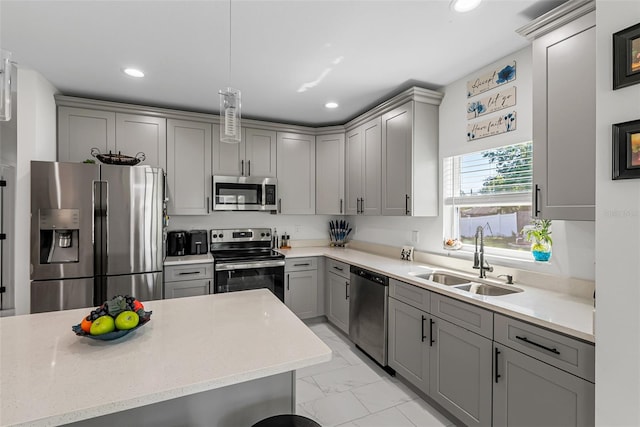 kitchen featuring gray cabinets, appliances with stainless steel finishes, marble finish floor, and a sink