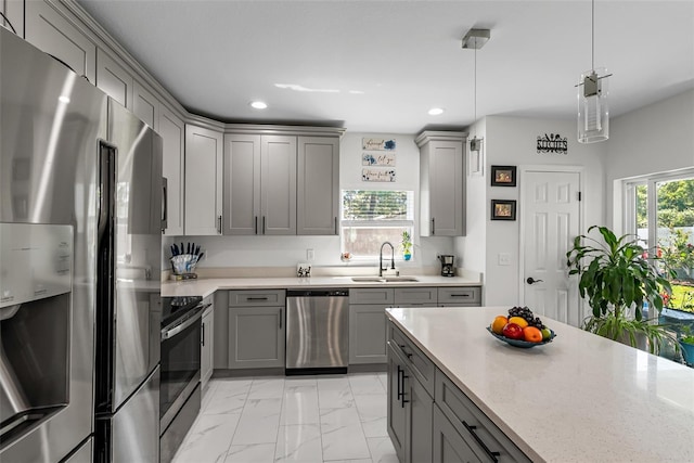 kitchen with a sink, recessed lighting, stainless steel appliances, gray cabinets, and marble finish floor