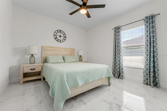 bedroom with marble finish floor, baseboards, and a ceiling fan
