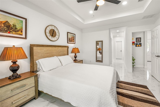bedroom with a tray ceiling, marble finish floor, visible vents, and recessed lighting