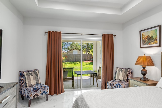 bedroom featuring access to exterior, a raised ceiling, and marble finish floor