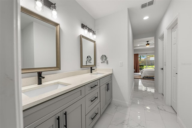 full bathroom featuring a sink, visible vents, baseboards, and marble finish floor