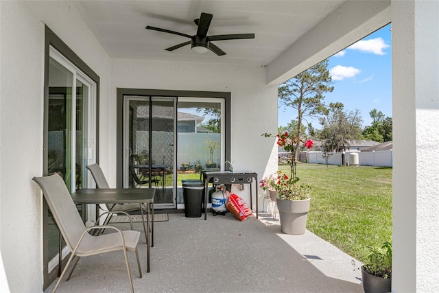 view of patio / terrace featuring ceiling fan and fence