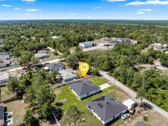 bird's eye view featuring a forest view and a residential view