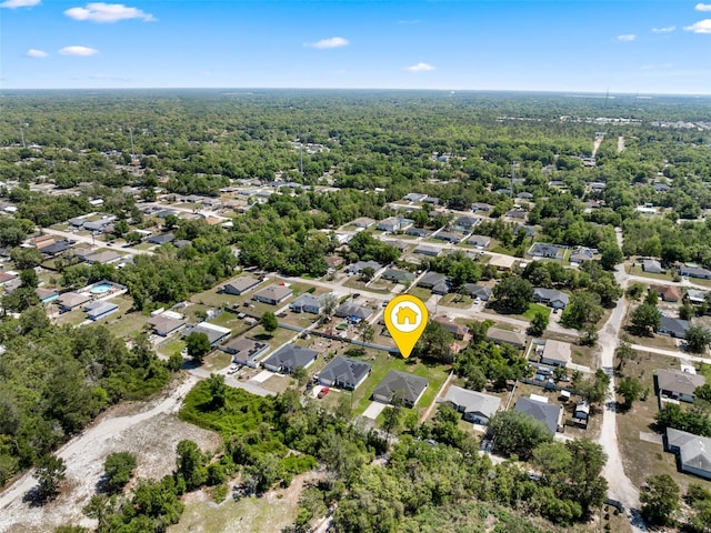 drone / aerial view featuring a forest view and a residential view